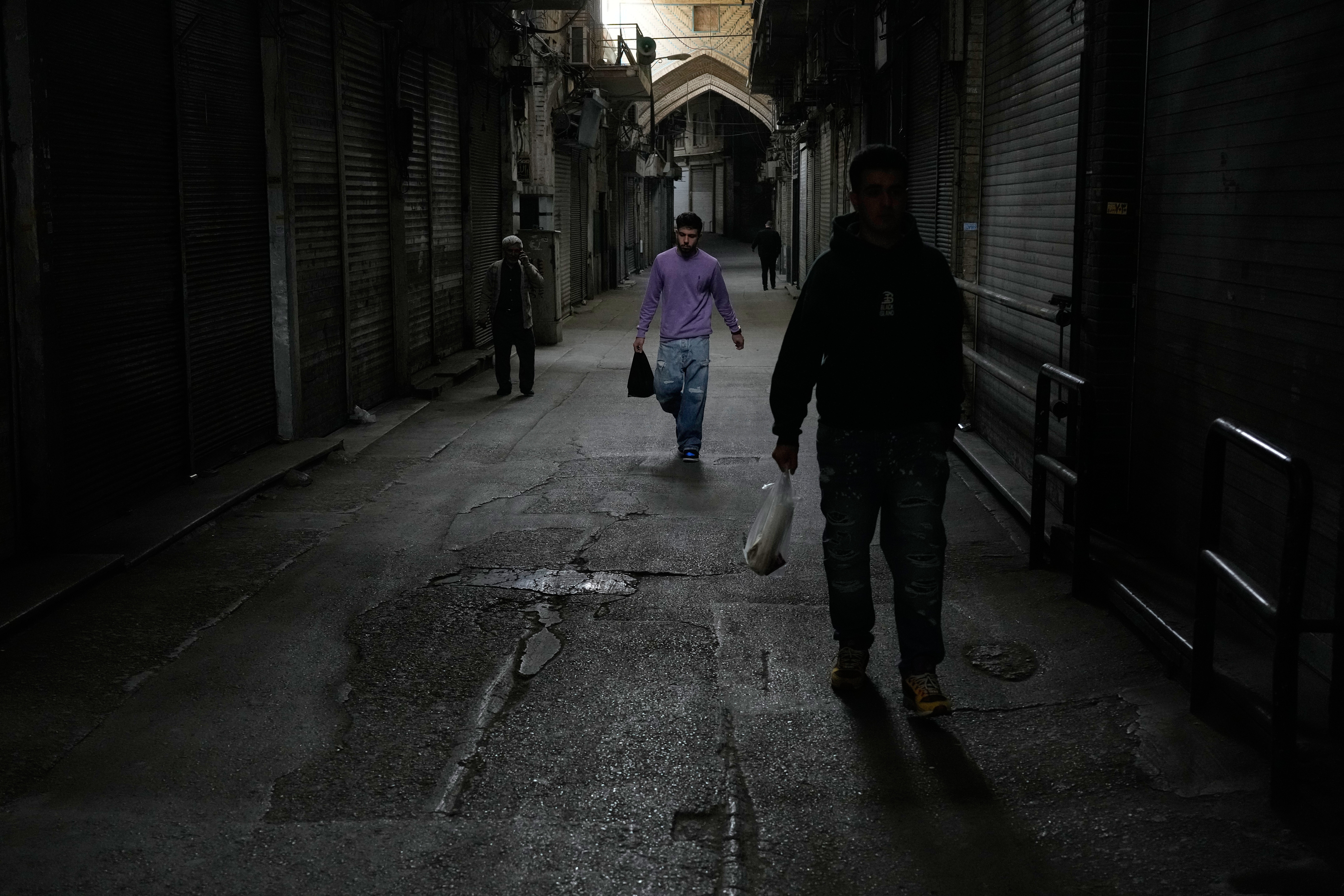 People walk past closed shops at the nearly empty traditional main bazaar during Iranian New Year, or Nowruz, holidays in Tehran, Iran, March 29, 2026.